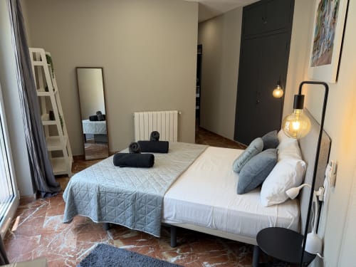 Modern bedroom at The Ruzafa Market Apartment in València with queen bed, city views, and contemporary decor