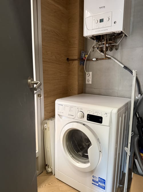 White washing machine in laundry room with boiler at Ruzafa Market Apartment, Valencia