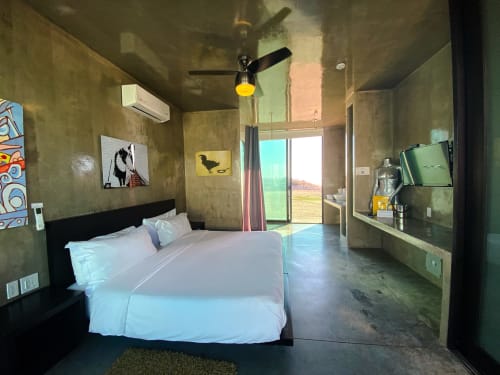 Modern king bedroom at Vidasoul BnB in La Vinorama with sea view, flat screen TV, and contemporary concrete design