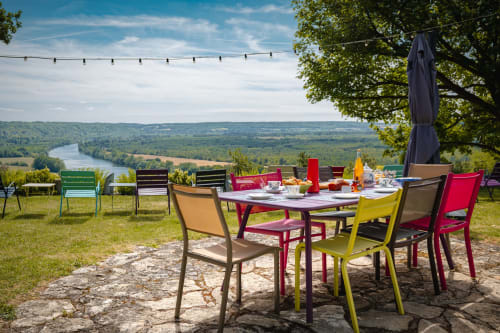 Colorful outdoor dining setup overlooking the Seine valley at Le Paradis de Lucile, La Roche Guyon