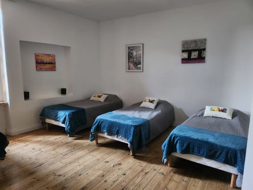 Triple bedroom with blue bedding at Domaine De Poulharies cottage in Carcassonne, France