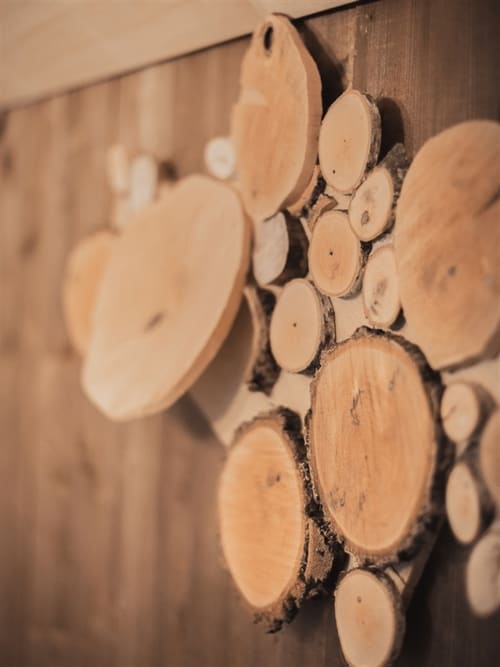 Stacked firewood logs at Les Murmures du Bois, a French countryside bed and breakfast with rustic garden charm