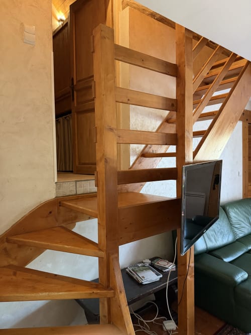 Wooden loft stairs in cottage at Domaine les Bertrands, Couches with bedroom mezzanine and garden view