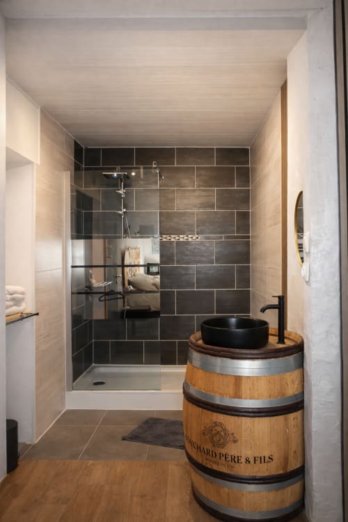 Salle de bain moderne avec douche spacieuse, vasque noire en tonneau de vin à l'Auberge La Source Bleue, Cusance, France
