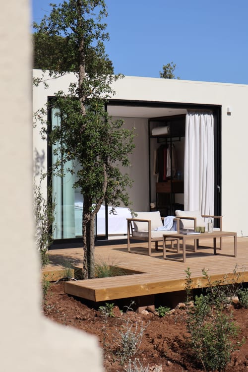 Terrazza moderna con arredi in legno, albero verde e porte scorrevoli in vetro a Quercia Private Nature Retreat a Maglie, Italia