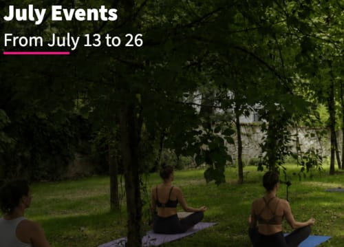 Yoga session at The Kraken Inn in Bergamo, guests meditating outdoors among trees