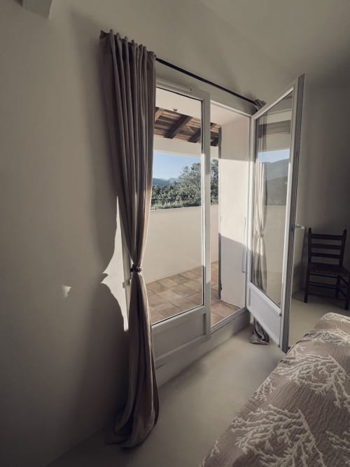 Chambre lumineuse avec portes-fenêtres donnant sur terrasse avec vue montagne à la villa RJD Conciergerie à Grasse