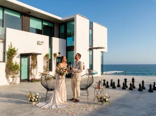 Pareja brindando en la casa de huéspedes frente al mar Vidasoul en La Vinorama, México con vistas al océano y arquitectura moderna