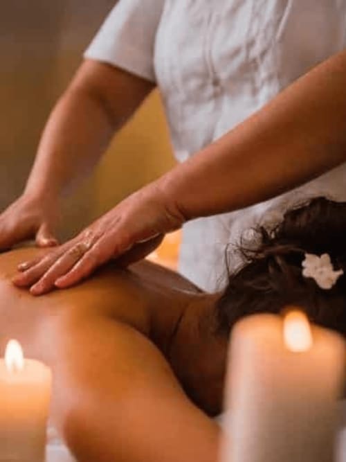 Therapeutic massage session at Les Murmures du Bois bed and breakfast in France, with candles