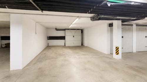 Espacio de garaje vacío en el apartamento Aloha Calpe en Calpe con paredes blancas y piso de hormigón
