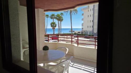 Vista de balcón en Aloha Calpe Sea Palm Apartment con mesa de comedor, palmeras y Mar Mediterráneo en Calpe, España