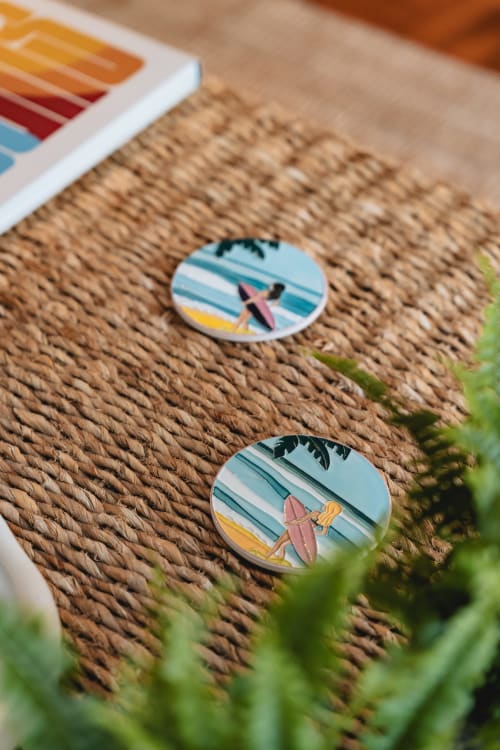 Colorful surfboard coasters on woven texture at Arestas e Planetas Cascais Garden House