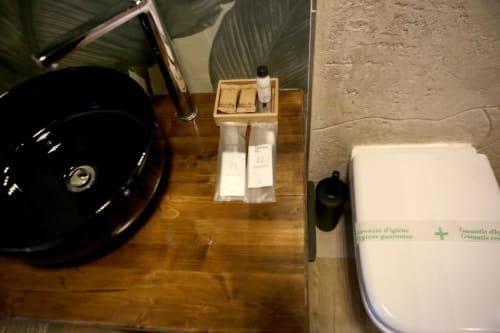 Vanity del bagno a Roma Imperial Suites con lavabo nero, portaccessori e bidet nella camera Deluxe
