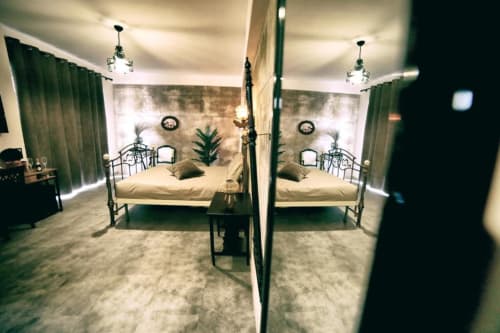 Camera quadrupla Marco Aurelio della Roma Imperial Suites B&B, con letti specchiati, dettagli verde e vista sulla città di Roma