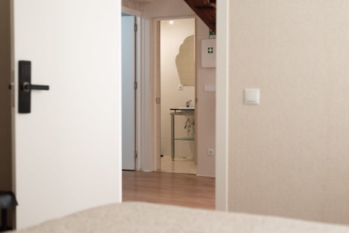Modern apartment hallway at Charme da Graça in Costa de Caparica, Lisboa, with open bedroom and bathroom views