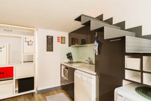 Compact apartment kitchen at Charme da Graça hotel in Belém, Lisboa with modern appliances and storage