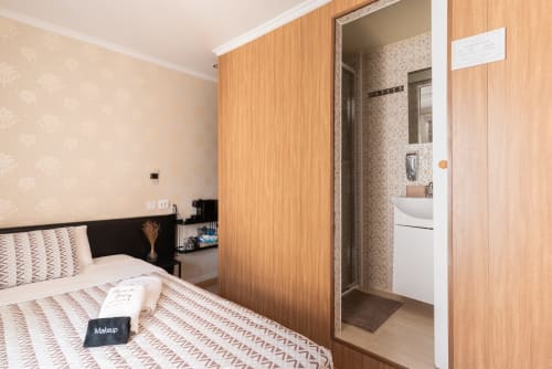 Double bedroom with balcony at Charme da Graça hotel, Lisbon, featuring en-suite bathroom and modern furnishings