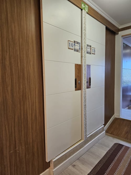 Hotel corridor at Charme da Graça Lisboa with modern room doors numbered 10 and 13, wooden finishes and contemporary design