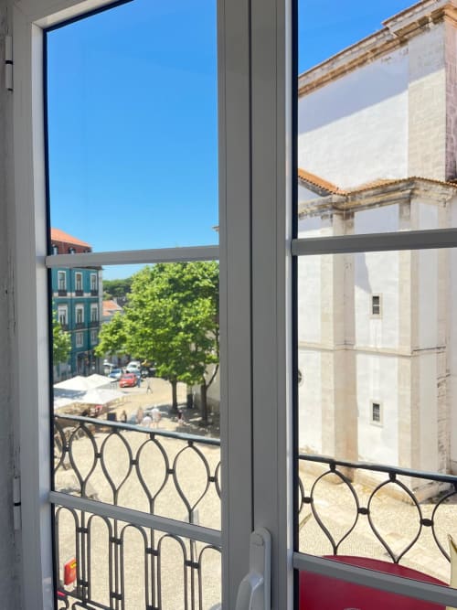 Charme da Graça hotel room balcony view in Lisboa overlooking historic architecture and square