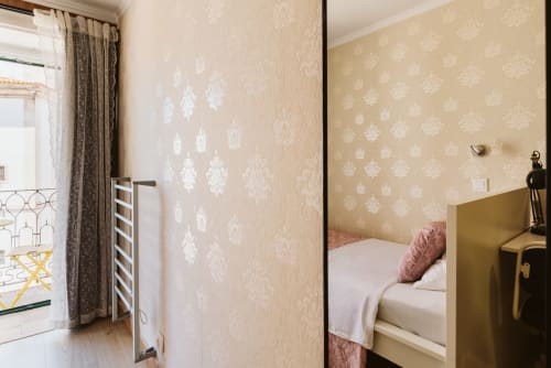 Single bedroom with balcony at Charme da Graça, Lisbon, featuring damask wallpaper and city views