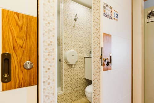 Small single bedroom bathroom at Charme da Graça hotel in Lisbon with mosaic tiles and shower