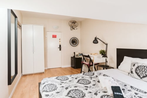 Charme da Graça hotel room 15B in Lisbon: cozy double bedroom with desk, fan, white wardrobe, and wooden floor