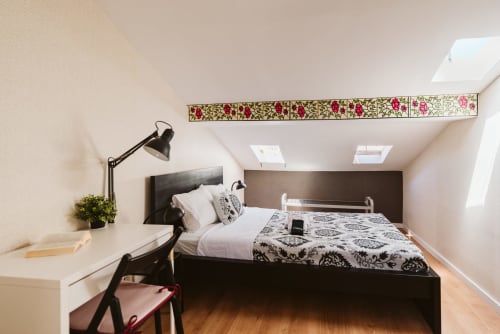 Charme da Graça hotel room 15B in Lisboa, double bedroom with black bed, desk, skylight and floral wall trim