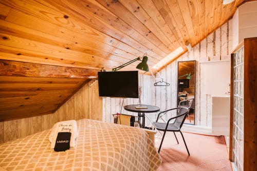 Charme da Graça hotel room 6B in Lisboa with wooden ceiling, bed, TV, desk area and mirror