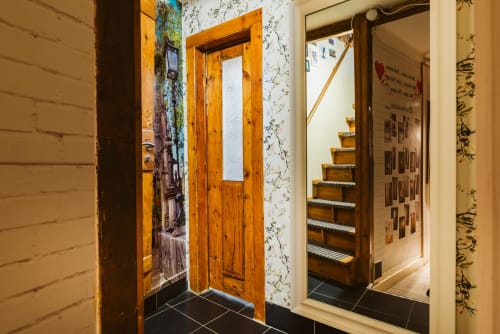 Charme da Graça hotel hallway with wooden doors, floral wallpaper, and staircase entry in Lisboa