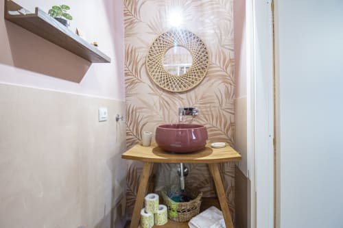Bagno della camera Corallo presso l'Epimoni B&B di Catania con lavabo in ceramica bordeaux, mobile in legno, specchio decorativo e elementi botanici