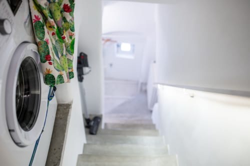 Lavanderia dell'appartamento Pietra & Luce a Ostuni con lavatrice e asciugamano a motivo di cactus
