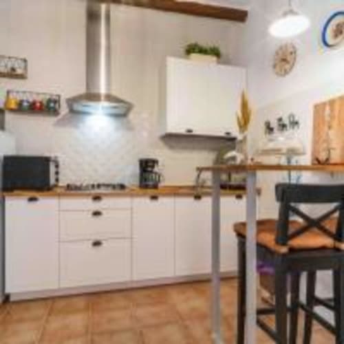 Cocina moderna con gabinetes blancos y encimeras de madera en la villa Cortijo La Suerte en Adra, España