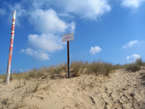 Dune de plage avec panneau d'accès à la plage et balise poteaux rouge et blanc à L'Aiguillon-la-Presqu'île, France