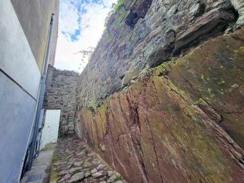 Historic stone walls and narrow alley at Cosy in Cork apartment, showing traditional Cork architecture