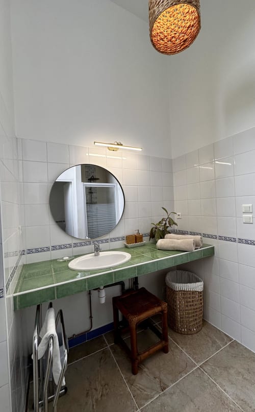 Modern bathroom in La Recreation cottage at historic 1850 school, Missillac, green countertop