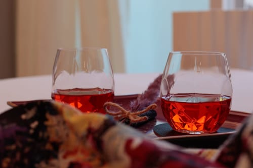 Two glasses of red wine with decorative elements at Pescara INN Family Connecting Suite