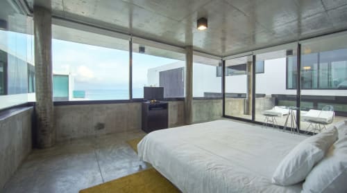 Junior King Suite at Vidasoul with ocean view, modern concrete architecture, white bedding, and terrace overlooking sea in La