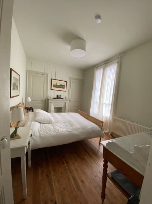 Chambre lumineuse du Gîte Presbytère de Hidden Bay Hotel à Cayeux-sur-Mer avec lit blanc, parquet et cheminée