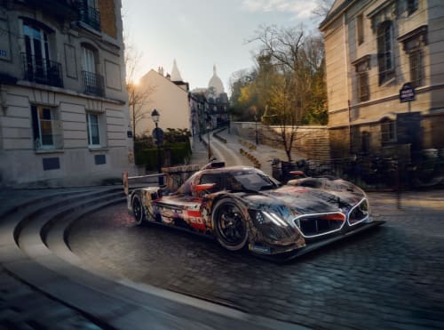Race car at L'Escapade hotel in Le Mans with Sacré-Cœur basilica backdrop