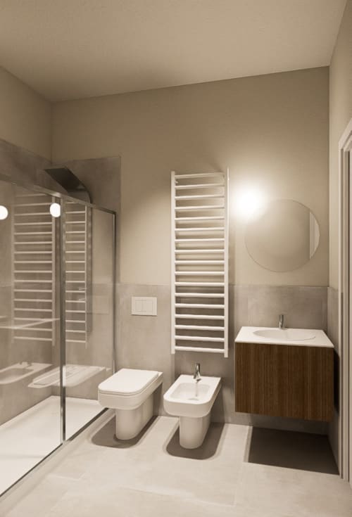 Bagno moderno presso Riviera Apartments a Pesaro con doccia, wc, bidet, lavabo, scaldasalviette e specchio rotondo