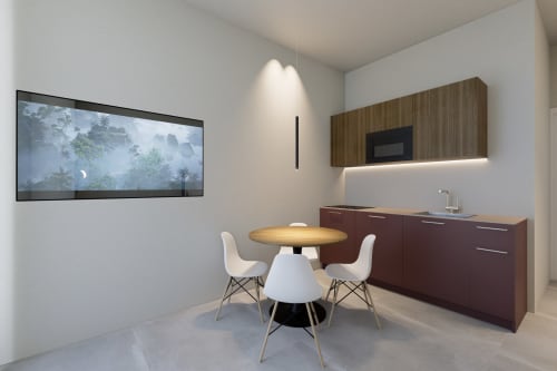 Angolo cottura moderno e zona pranzo nella bilocale con vista mare di Riviera Apartments a Pesaro con tavolo rotondo e due sedie bianche