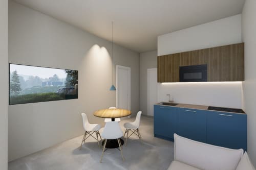 Moderna zona cucina-soggiorno nelle Riviera Apartments Pesaro con mobili blu, tavolo tondo e vista mare sulla TV