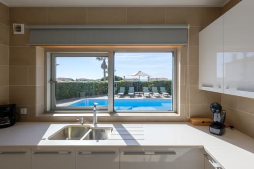 Cozinha moderna com pia e vista para a piscina na Vila Maravilhosa Be SilverCoast em Serra D'El Rei, Portugal