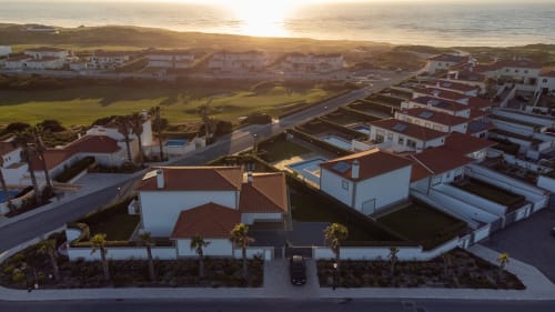 Vista aérea da villa Be SilverCoast com telhado de barro, piscina privada e vista para o oceano ao pôr do sol em Serra D'El Rei, Portugal