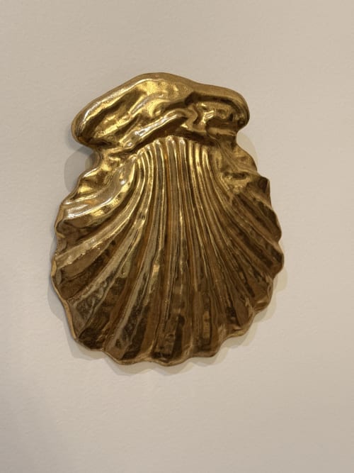 Sculpture en relief de coquillage doré ornementé dans la chambre du gîte Le Montreal