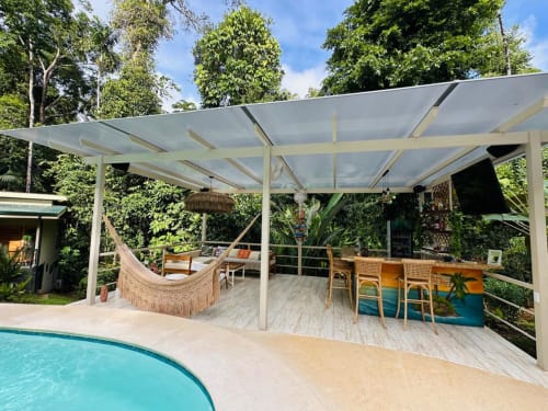 Fauna Lodge deck with shaded pergola, hammock, dining area, and pool in Osa Peninsula, Costa Rica