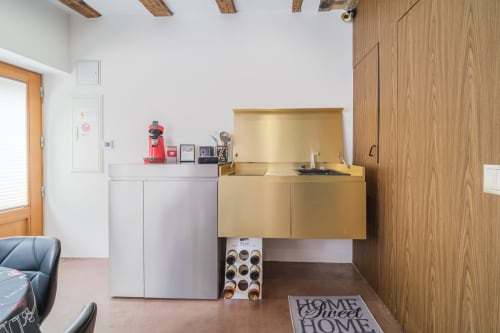 Modern kitchenette with gold cabinetry in La Semeuse Hurst apartment at Les Ambrades, Colmar