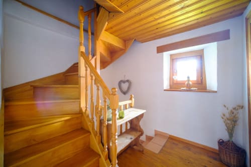Wooden staircase in Les Ambrades villa, Eguisheim with exposed beams and rustic decor