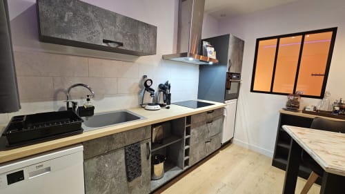 Cuisine moderne équipée dans l'appartement Secret'Eden & spa44 de la Résidence L'Hermitière, avec mobilier béton et bois