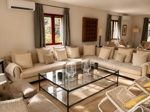 Spacious beige living room with L-shaped sofa at El Escondite De Pedro Malillo in Candeleda, Spain